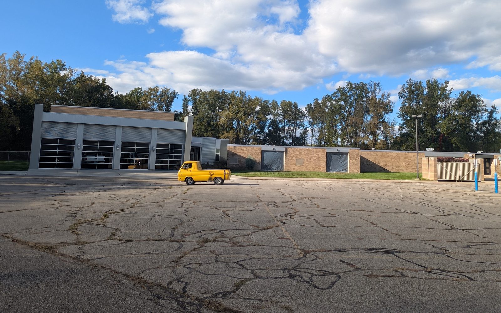 A yellow Dodge A100 pickup in the front lot at 155 E. Glass Rd., where Cars and Coffee is held.